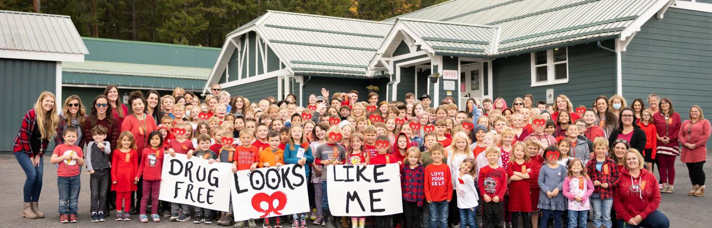 Students hold signs reading "Drug Free Looks Like Me"