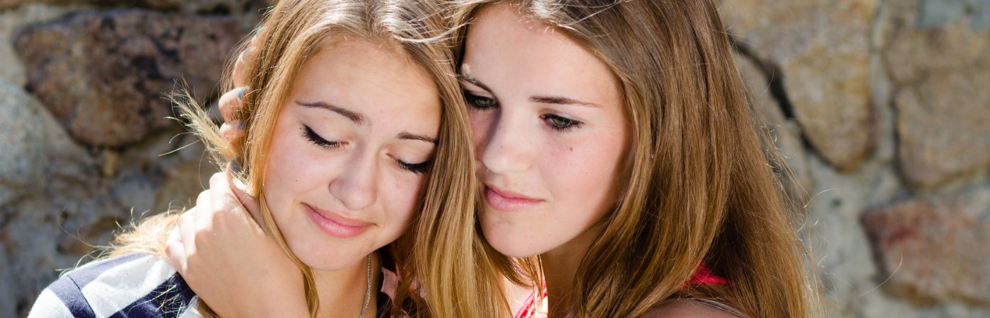 Teen girl comforts friend