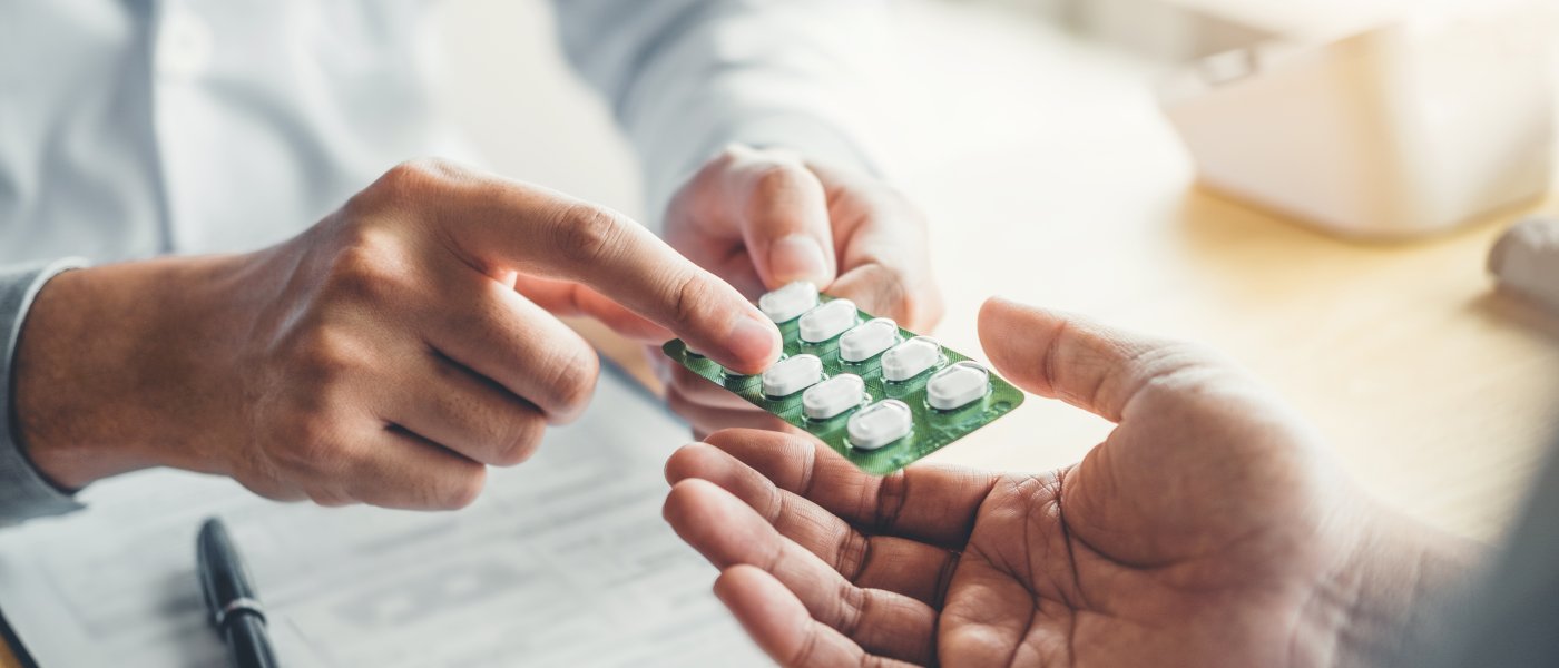 Doctor explains prescription pills to a patient