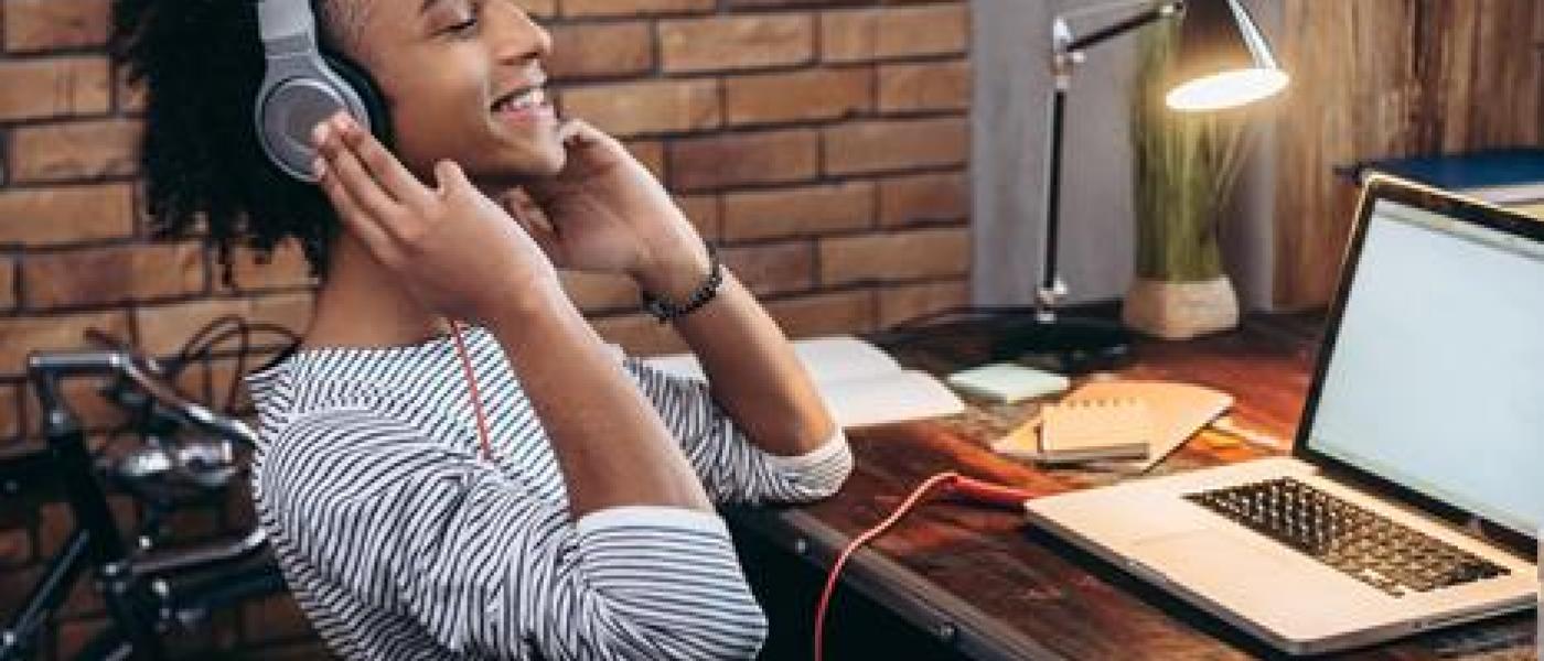 teen boy at laptop with headphones