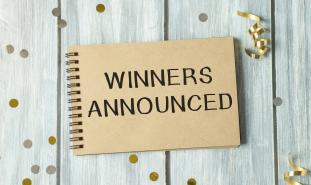 winners announced written on notebook