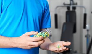 boy holding pills