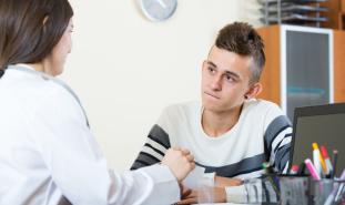 teen boy talking to doctor