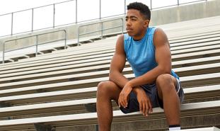 teen sitting in bleachers